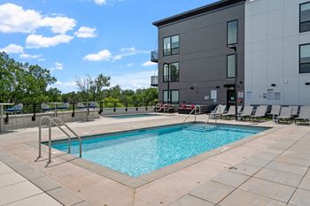 our apartments have a swimming pool with chairs around it